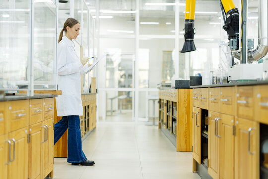 Young female lab assistant portrait in real laboratory setting