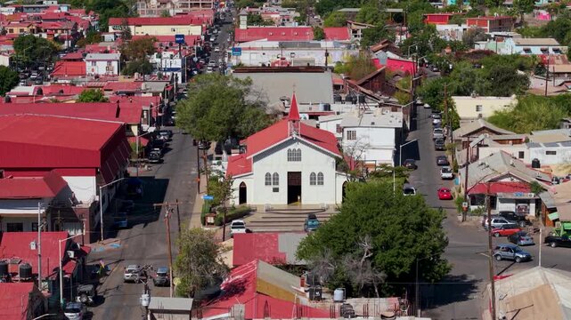 View aerial shots of Santa Rosalia, showcasing the Eiffel church Iglesia Santa Barbara, towns streets, buildings, and unique architecture in Baja California, Sur, Mexico.