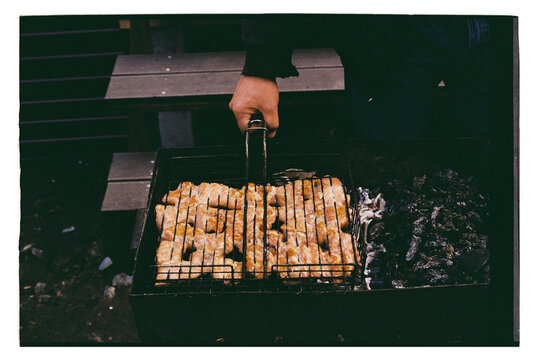 Hands hold bowl of cooked meat pieces
