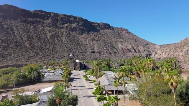 Watch the sunrise over San Javier Mission in Baja California Sur near Loreto with aerial views of the town and surrounding palm trees