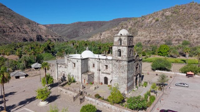 Witness the San Javier Mission in Baja California Sur at sunrise showcasing aerial views of the historic site and surrounding greenery