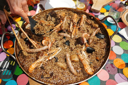 Friends Enjoy Seafood Paella. UGC. Spain