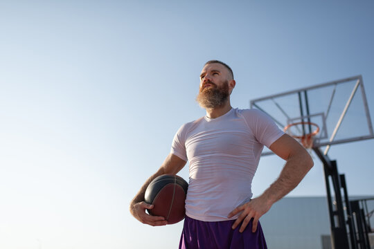 Self assured streetball player against blue sky