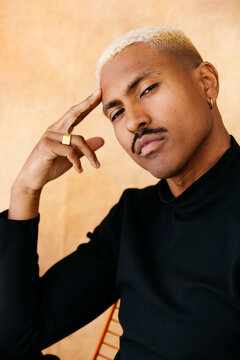 Stylish man with dyed hair showing confidence