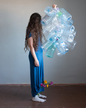 Woman full body portrait with plastic bottles 17
