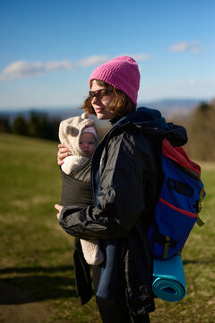 Mother hiking with baby in carrier outdoors