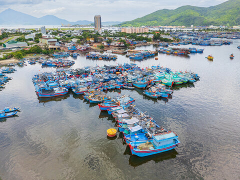 Colorful fishing boats tied closely together in abstract patterns