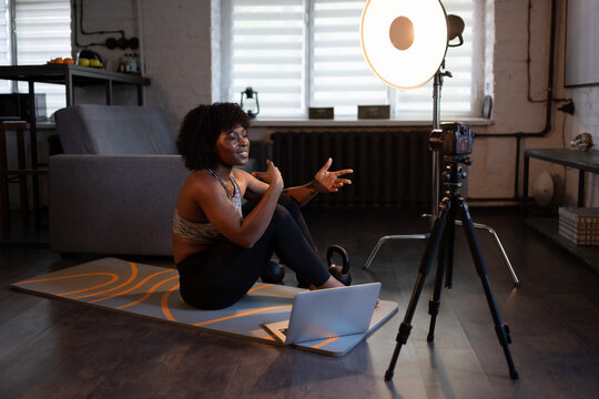 Cheerful black female coach speaking to camera