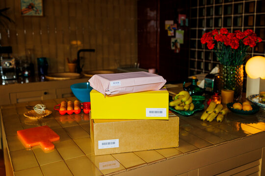 Delivery packages arriving in a home kitchen ugc