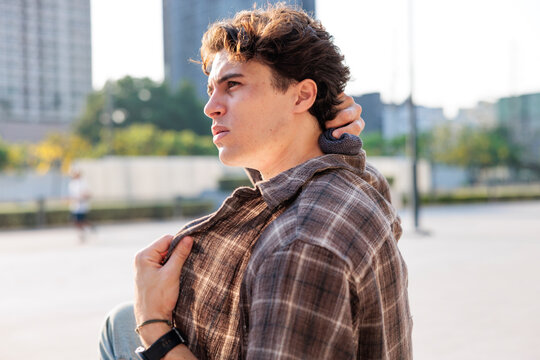 Man applying wet towel to neck during extreme heatwave outdoors