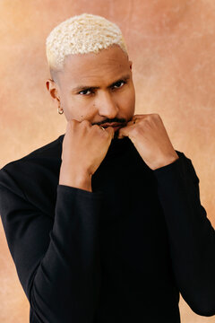 Man pulling black turtleneck