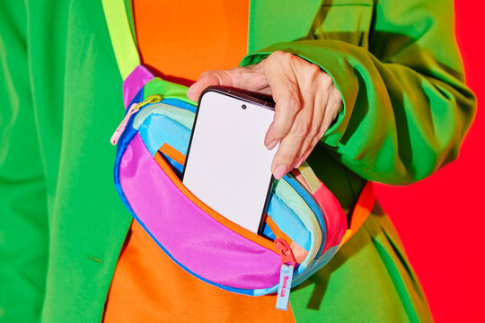 Person Pulling Smartphone from Colorful Waist Bag. Blank, mock-up. 