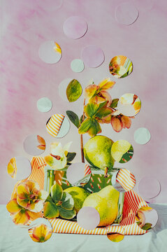 Flowers and fruits in glass with polka dots on pink background