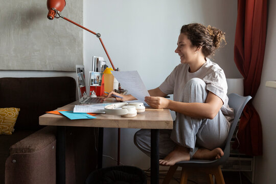 Person working from home with laptop and documents