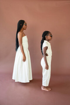 Two Girls Standing Side by Side in a Studio Setting