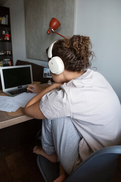Person studying online at home with headphones