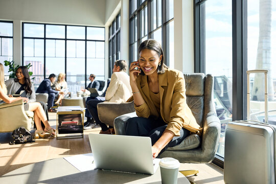 Businesswoman during phone call using laptop
