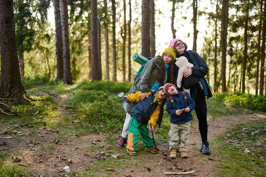Happy family with kids posing during forest hike