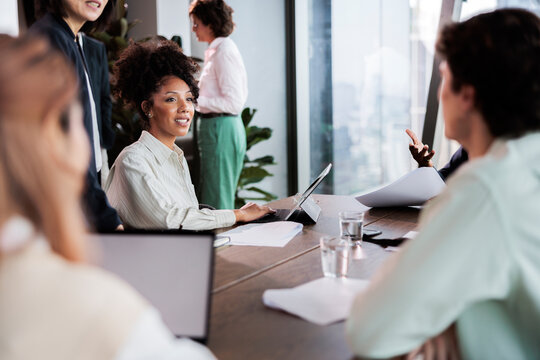 Diverse team collaborates at a modern office meeting.