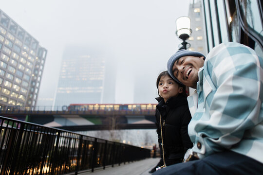 Father and daughter bonding in London city fog