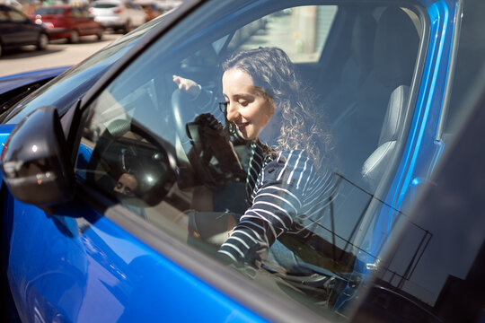 Woman driving modified car using hand controls