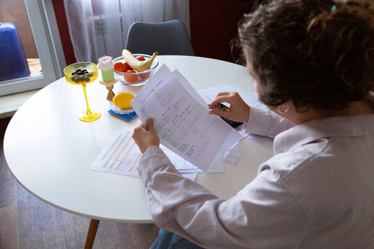 Person doing home budget, managing monthly finances