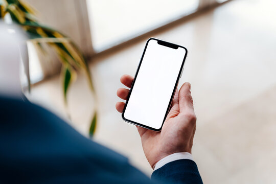 Hand holding white screen phone