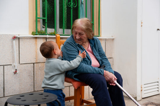Toddler touching grandmother face