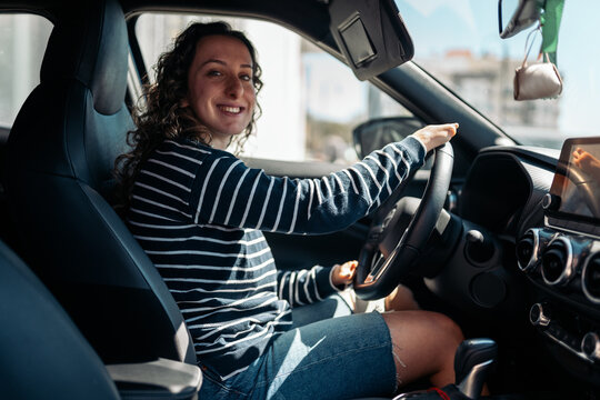 Smiling woman with phocomelia driving car independently