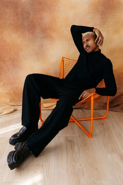 Man sitting in orange chair