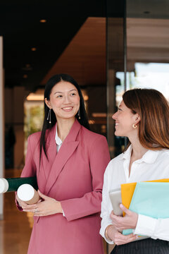 Portrait of two young cheerful women at work