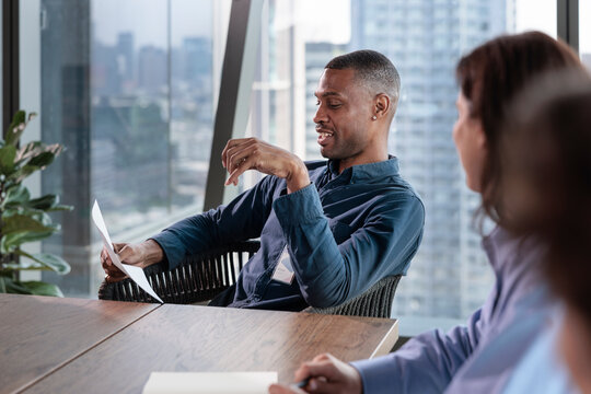 Business meeting in a modern office with city view.