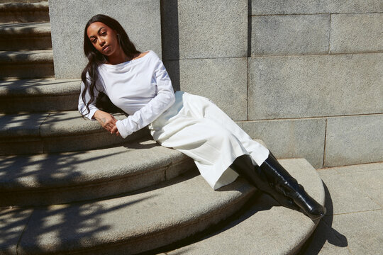 Woman on stair case in fashion outfit