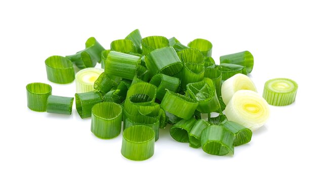 Chopped scallions. Green and white sliced scallions sit atop a white surface, isolated. Fresh and flavorful food