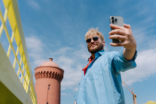 Low angle selfie under blue sky