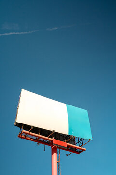 Blank billboard displaying white and blue background against sky