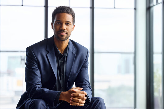 Businessman in a Suit Sits in an Office