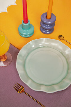 Green ceramic plate on festive table serving flat lay