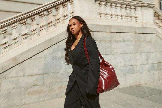Motion blur photo of woman on urban street in fashion outfit