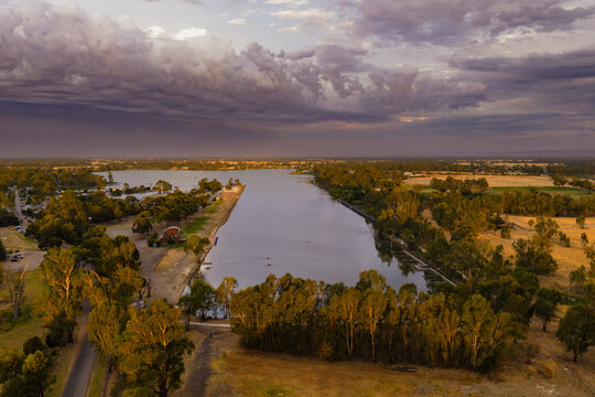 Dramatic cloud band and late evening light over a rowing course