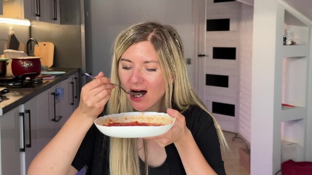 Blonde White Woman Sipping Glass Water Between Bites At Table Small Kitchen Backdrop Reflective Pause