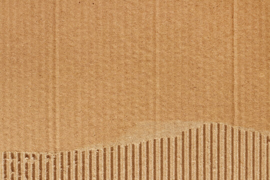 Brown cardboard sheet abstract background, texture of recycle paper box in old vintage pattern with ripped edges.