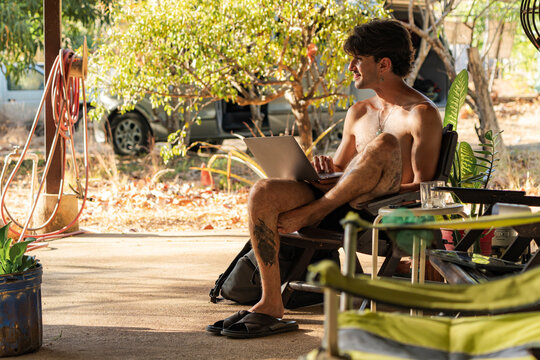 Young man using laptop working remotely outdoors