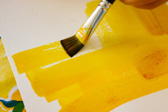 Hand Painting with Yellow Brush on Canvas