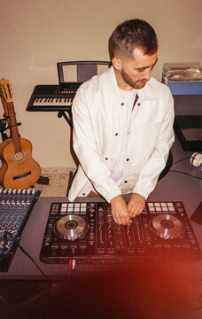 Analog image of a DJ mixing music in his home studio