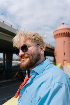 Blond man portrait with tower in background