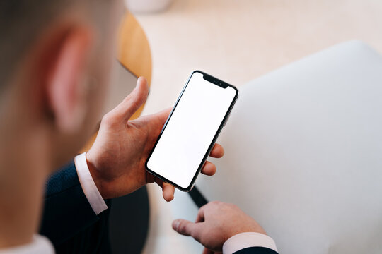 Hand holding white screen phone