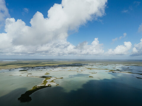 Aerial lagoon and wetland under dramatic clouds in Tulum
