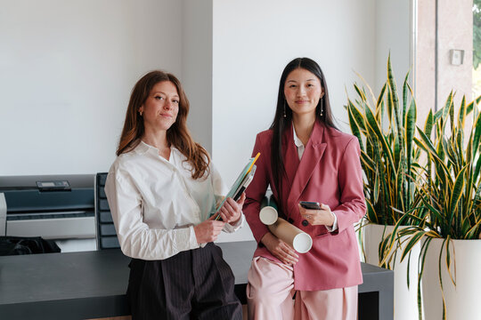 Portrait of two confident professional women at work