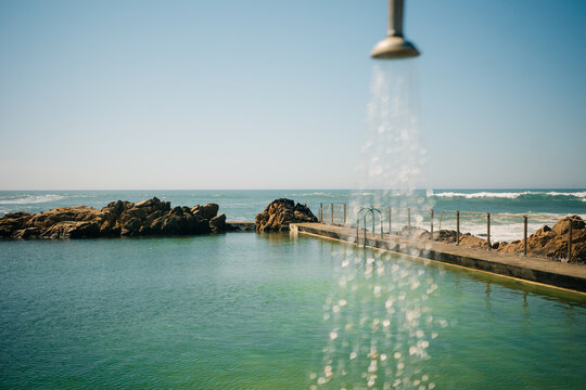 Enjoying a Sunny Day by the Ocean With a Shower View